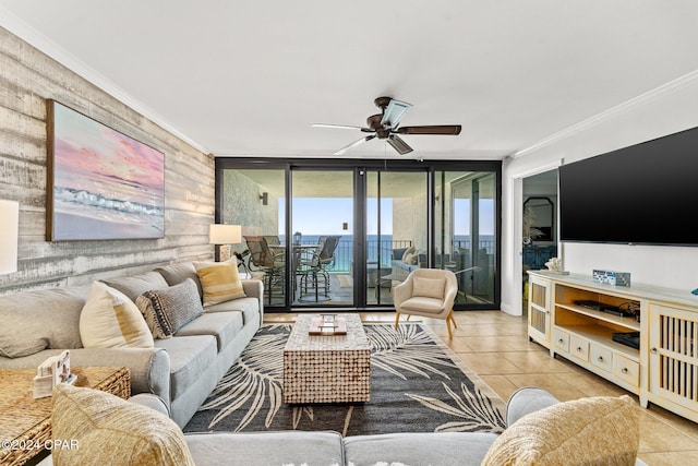 tiled living room with floor to ceiling windows, ornamental molding, and ceiling fan