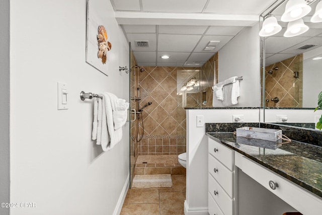 bathroom featuring tile patterned floors, a shower with door, vanity, and toilet