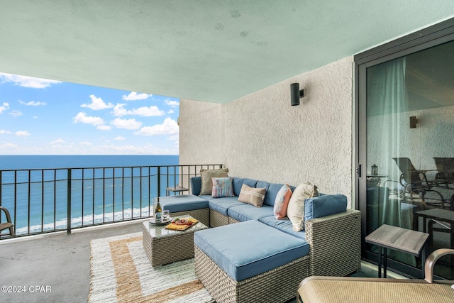 balcony with a water view and an outdoor hangout area