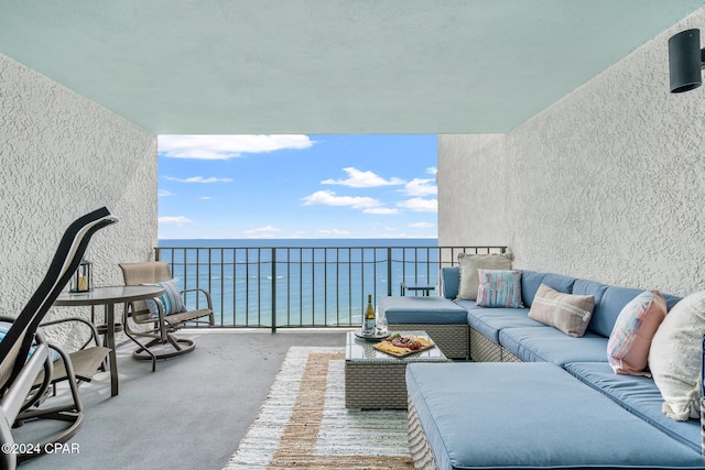 balcony with an outdoor living space and a water view