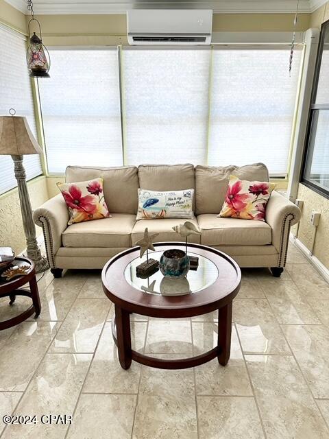 sunroom / solarium featuring a healthy amount of sunlight and a wall mounted AC