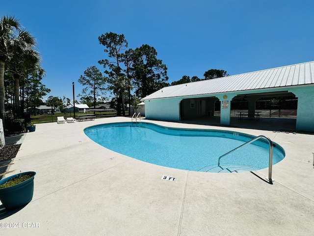 view of swimming pool featuring a patio