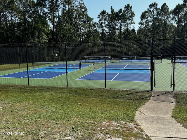 view of sport court featuring a yard