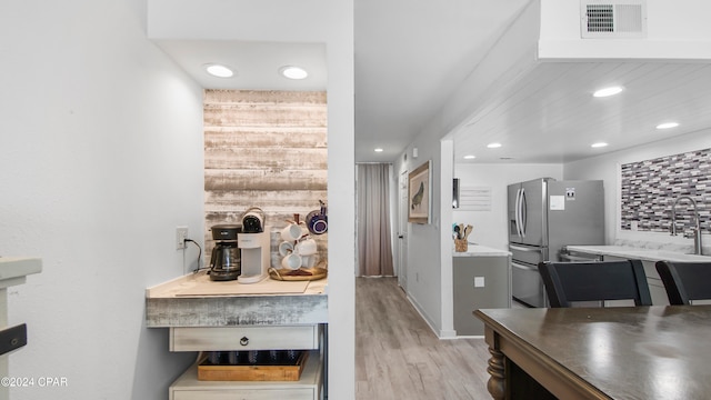 bathroom with stacked washer / dryer, vanity, and walk in shower