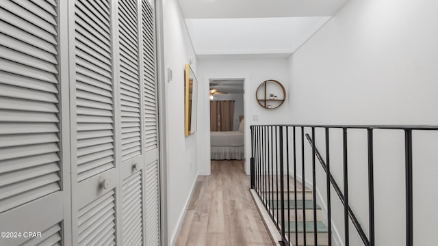 hallway with light hardwood / wood-style flooring