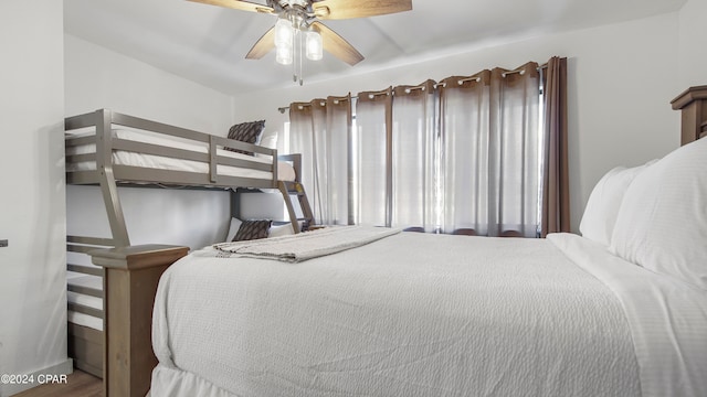 bedroom with ceiling fan and hardwood / wood-style flooring