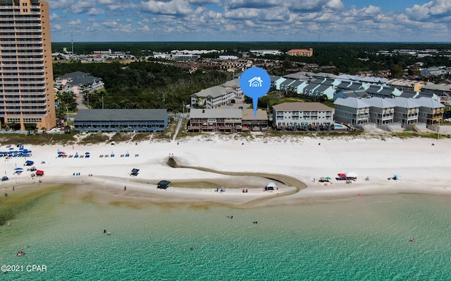 bird's eye view with a water view and a beach view