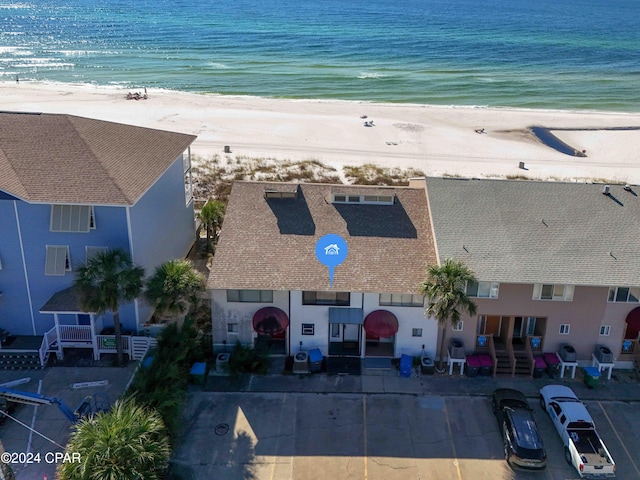 bird's eye view with a water view and a beach view