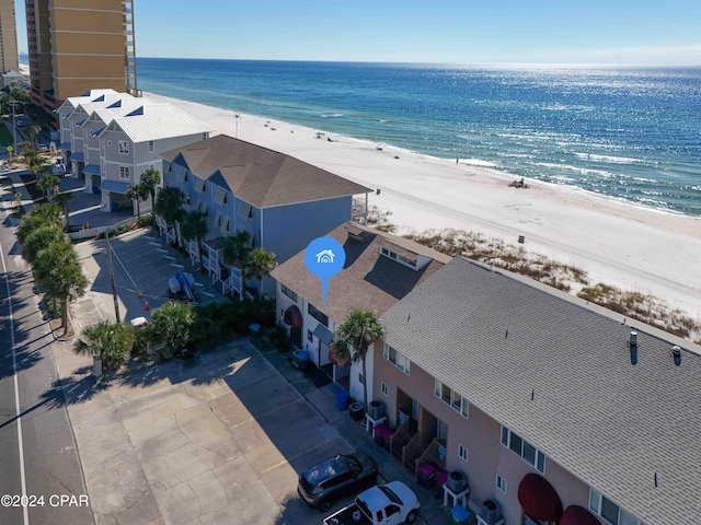 birds eye view of property featuring a water view and a beach view