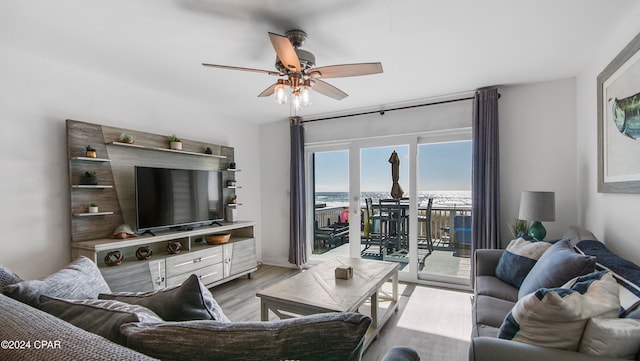 living room with ceiling fan and light hardwood / wood-style flooring