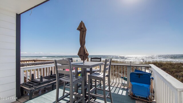 deck with a view of the beach and a water view