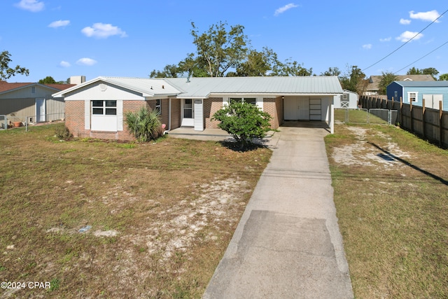 view of front facade featuring a front lawn and a carport