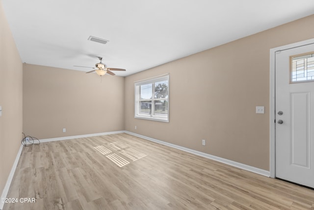 foyer featuring a wealth of natural light, light hardwood / wood-style flooring, and ceiling fan