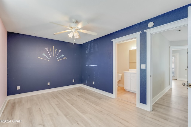 unfurnished bedroom featuring connected bathroom, light hardwood / wood-style flooring, and ceiling fan