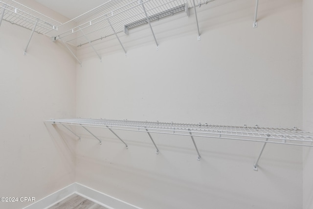 spacious closet featuring hardwood / wood-style floors