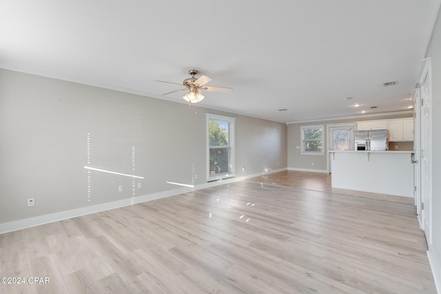 unfurnished living room with crown molding, ceiling fan, and light hardwood / wood-style floors