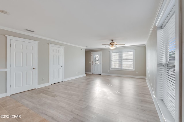 unfurnished living room featuring ceiling fan, light hardwood / wood-style floors, and ornamental molding