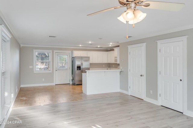 kitchen with white cabinets, kitchen peninsula, light hardwood / wood-style flooring, ornamental molding, and stainless steel fridge with ice dispenser