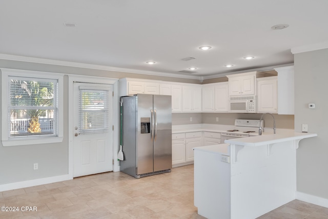 kitchen featuring a breakfast bar, white cabinetry, white appliances, and kitchen peninsula