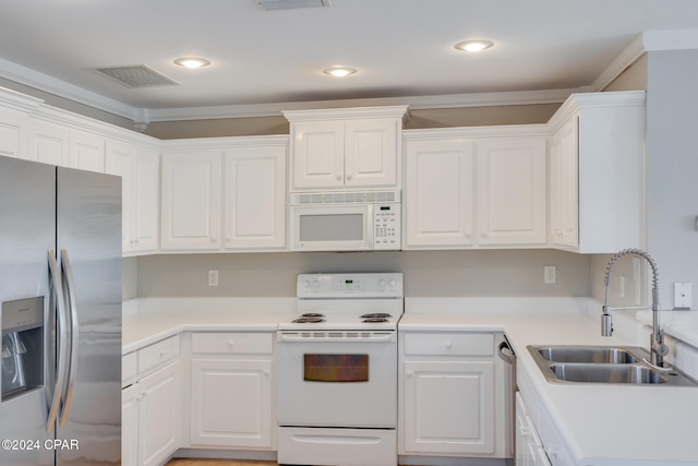 kitchen with appliances with stainless steel finishes, white cabinetry, and sink