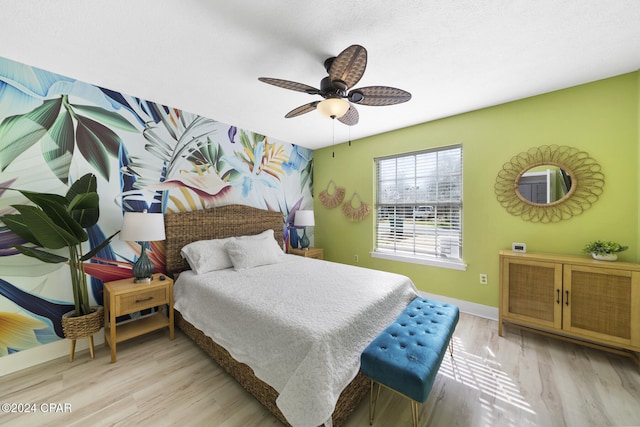 bedroom with ceiling fan and light hardwood / wood-style floors