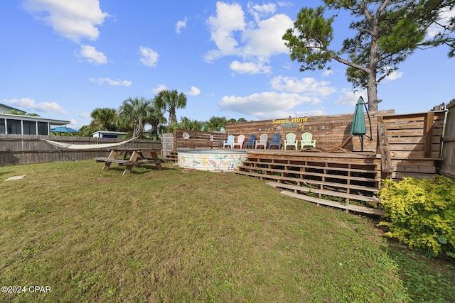 view of yard with a swimming pool side deck