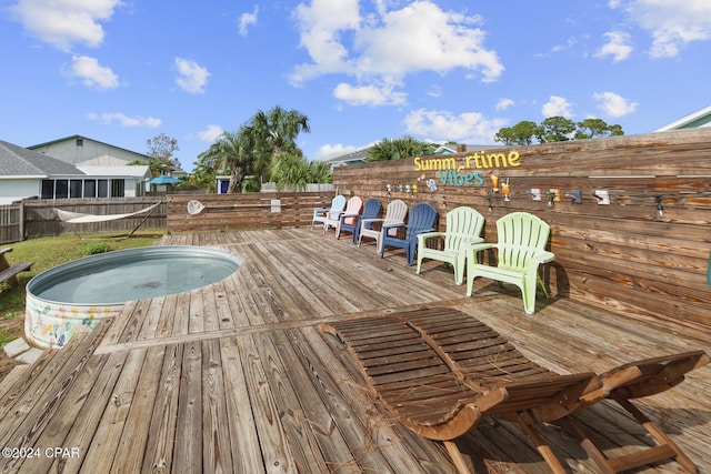 wooden terrace featuring a hot tub