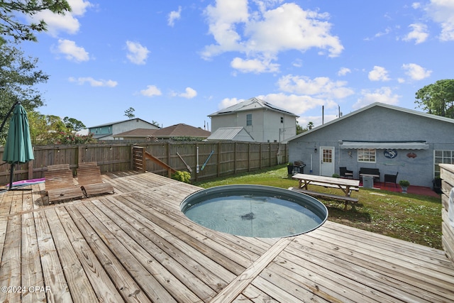 view of pool with a lawn and a deck