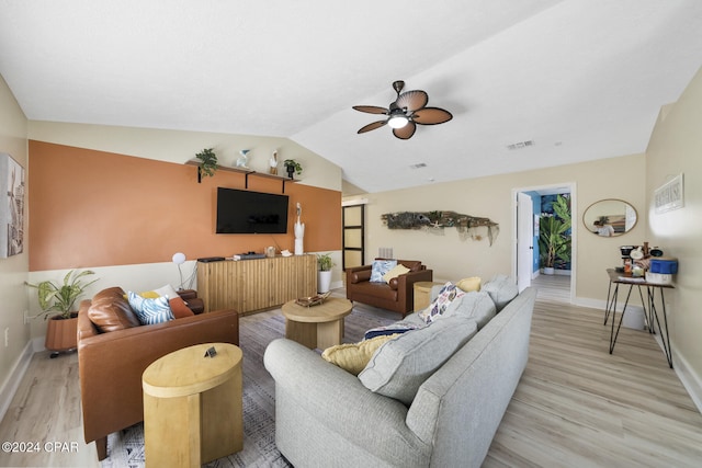 living room featuring ceiling fan, lofted ceiling, and light wood-type flooring