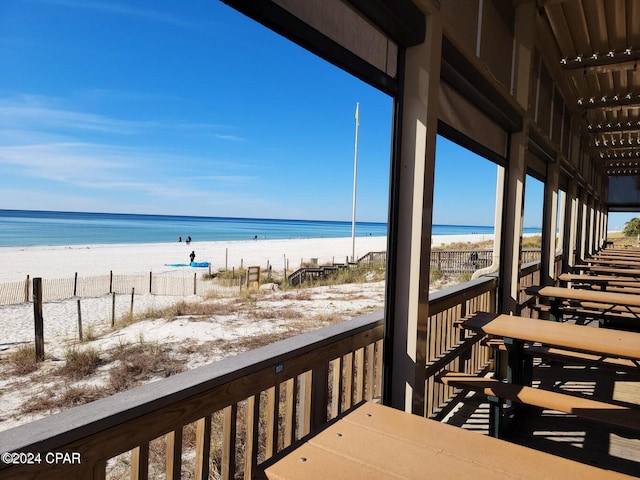 exterior space featuring a water view and a beach view