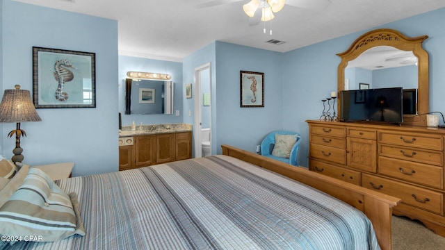 bedroom with ensuite bath, ornamental molding, ceiling fan, sink, and carpet floors