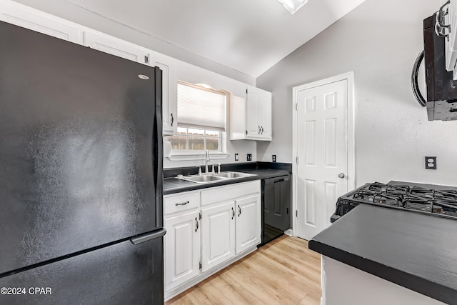 kitchen with sink, light hardwood / wood-style flooring, vaulted ceiling, white cabinets, and black appliances