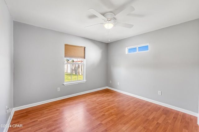 spare room with ceiling fan and light wood-type flooring