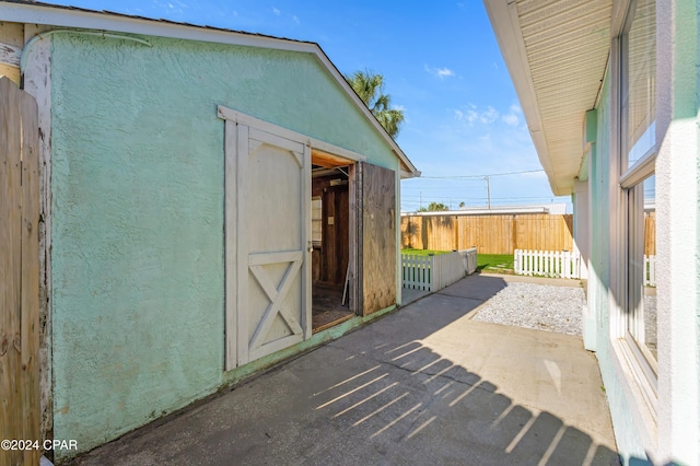 view of patio featuring a storage shed