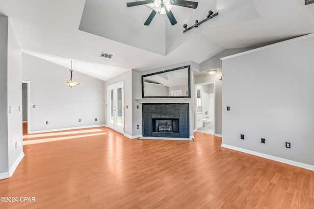 unfurnished living room with a fireplace, light hardwood / wood-style flooring, ceiling fan, and lofted ceiling