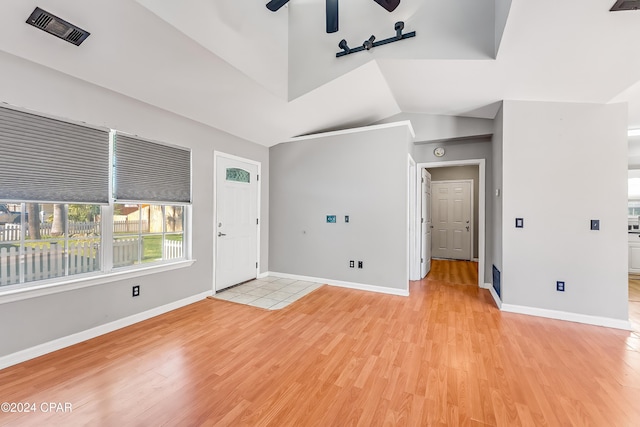 interior space with light hardwood / wood-style floors, ceiling fan, and lofted ceiling