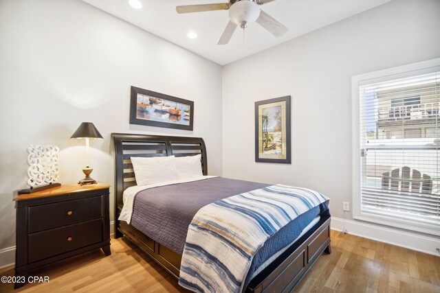 bedroom with ceiling fan and light hardwood / wood-style floors