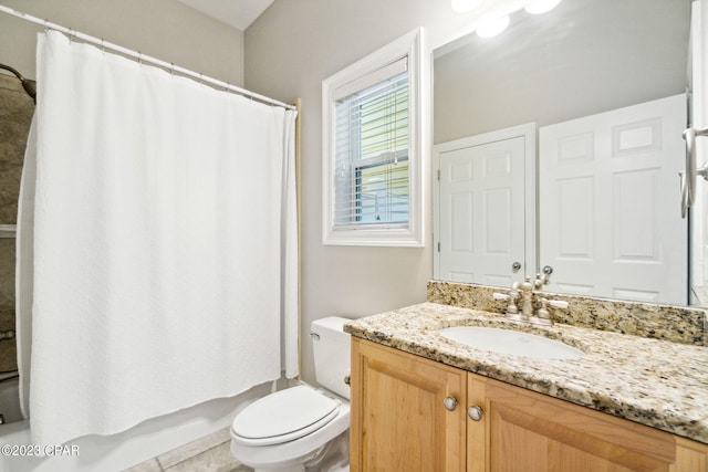 bathroom featuring tile patterned floors, vanity, and toilet