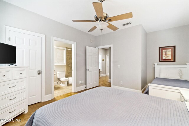 bedroom featuring ceiling fan, ensuite bathroom, and light hardwood / wood-style floors