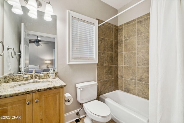 full bathroom with vanity, toilet, ceiling fan, and shower / tub combo with curtain