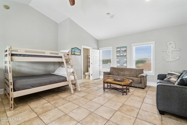 tiled bedroom with ceiling fan and lofted ceiling