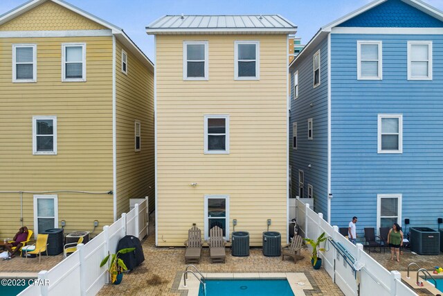 rear view of property featuring a patio area and cooling unit