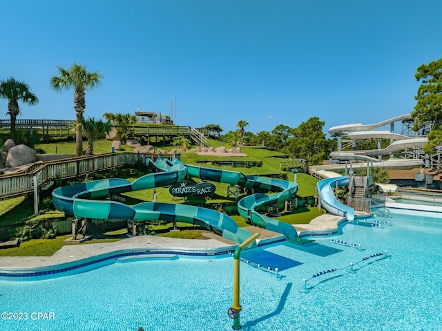 view of pool with a water slide