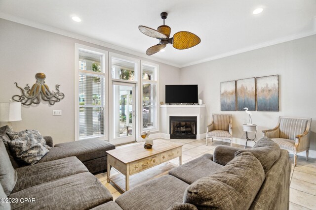 living room featuring light tile patterned floors, ceiling fan, and ornamental molding