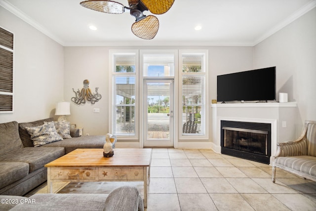 tiled living room with ceiling fan and ornamental molding