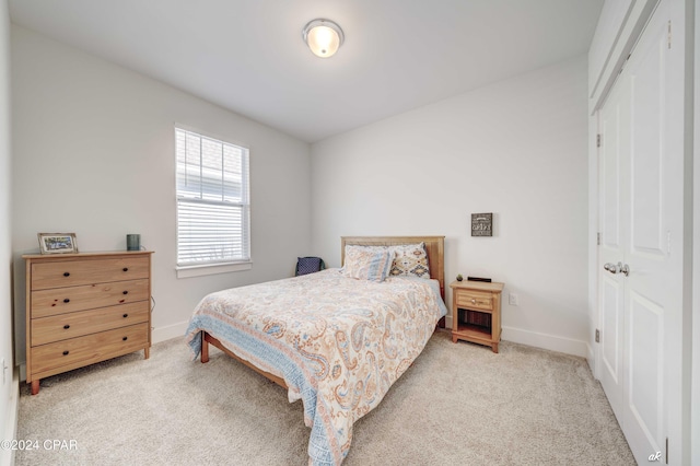 carpeted bedroom featuring a closet