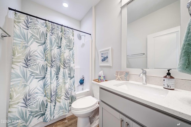 full bathroom featuring shower / bathtub combination with curtain, toilet, vanity, and hardwood / wood-style flooring