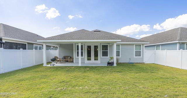 rear view of house with french doors, a yard, and a patio area