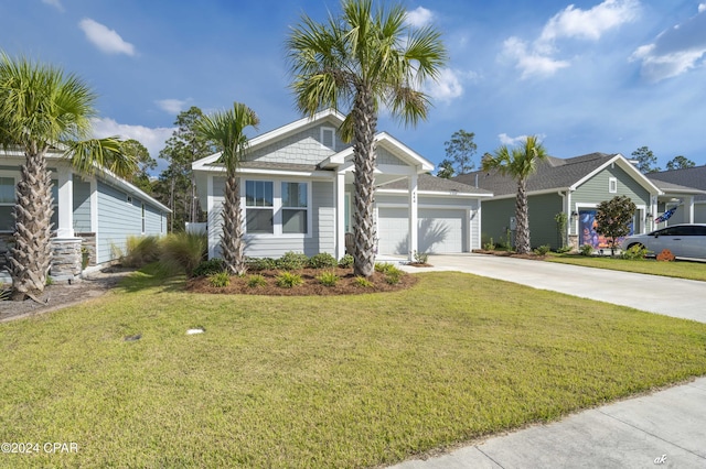 view of front of property featuring a front yard and a garage