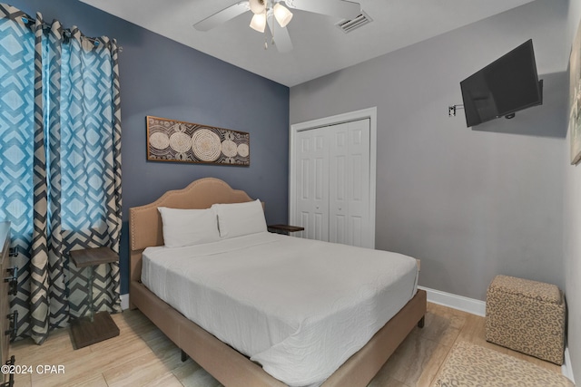 bedroom with ceiling fan, a closet, and light hardwood / wood-style flooring